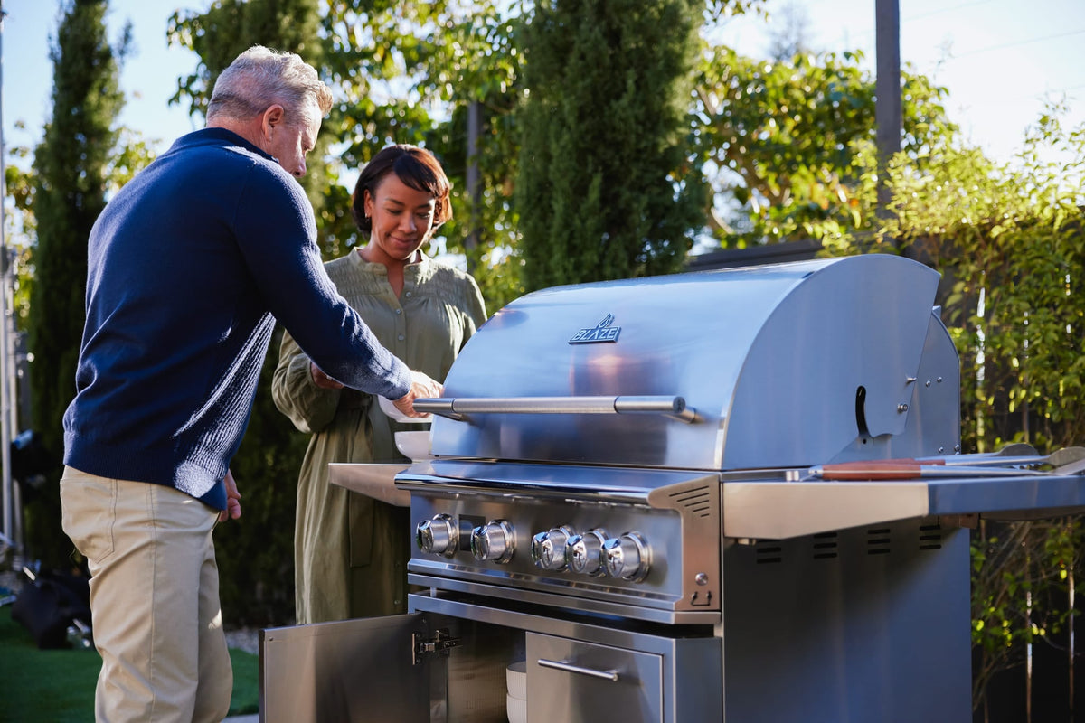 Blaze LTE PRO 32-inch 4-burner built-in gas grill, in use on a backyard patio