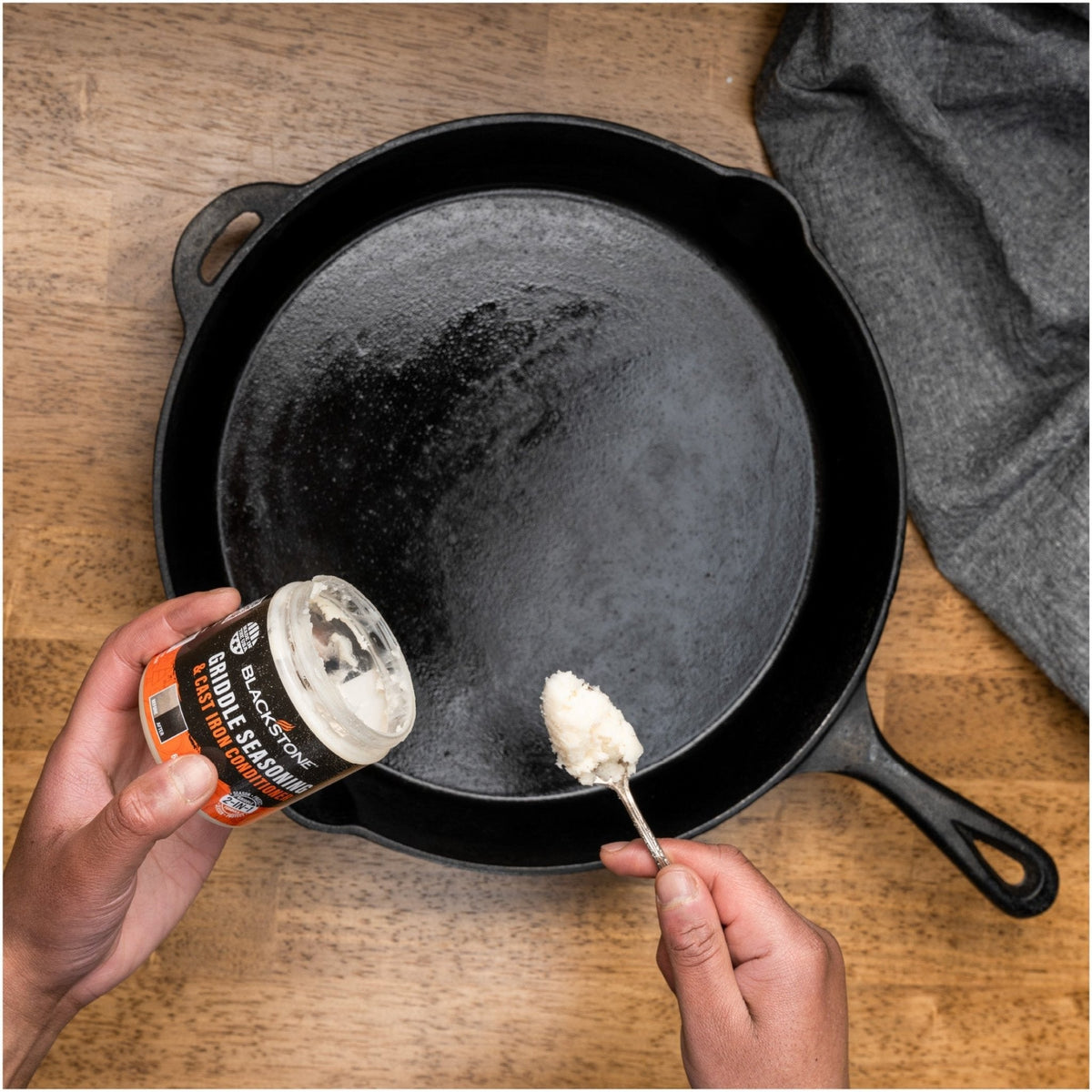Blackstone griddle seasoning and cast iron conditioner, applying to a cast iron skillet
