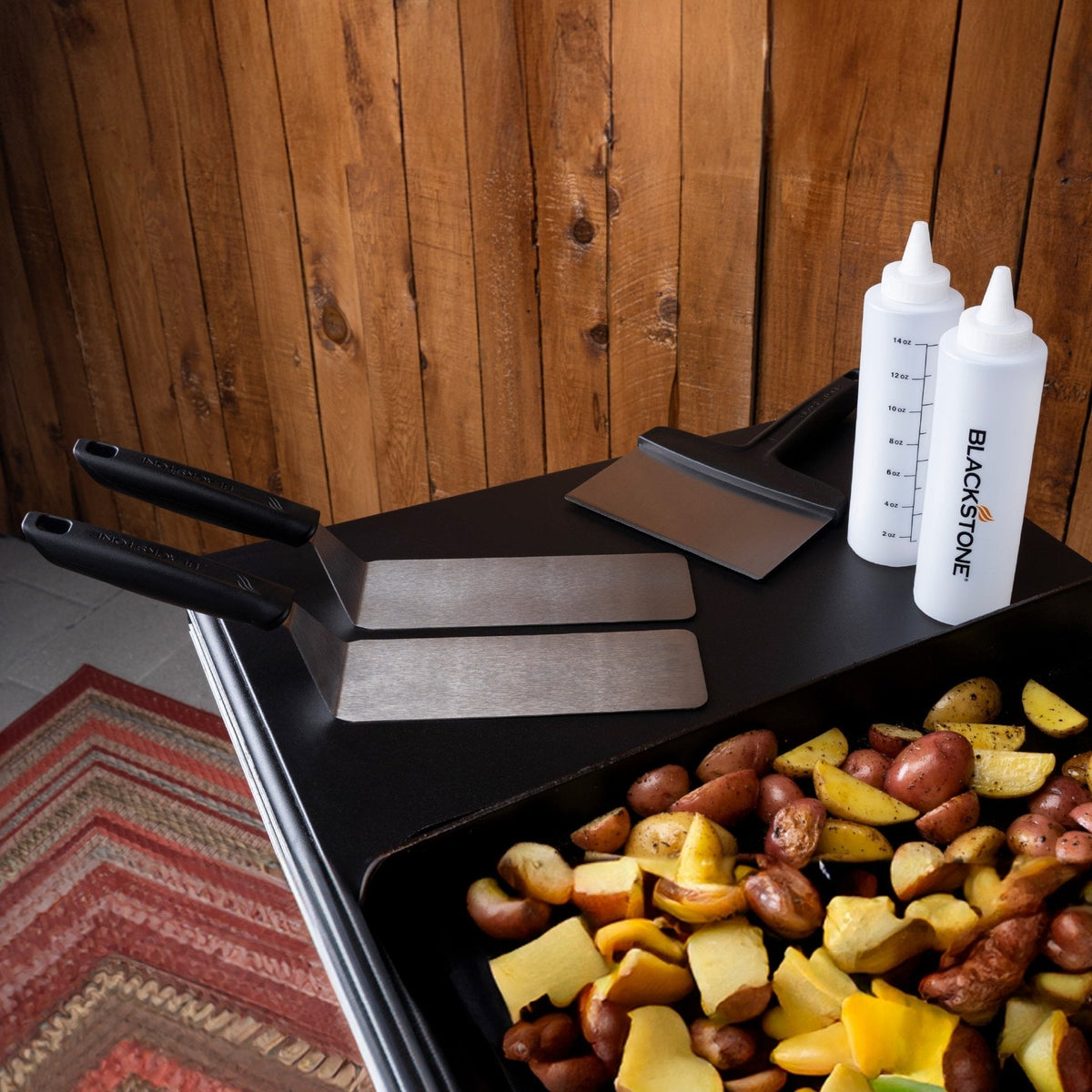 Blackstone 5-piece griddle toolkit, tools beside a griddle