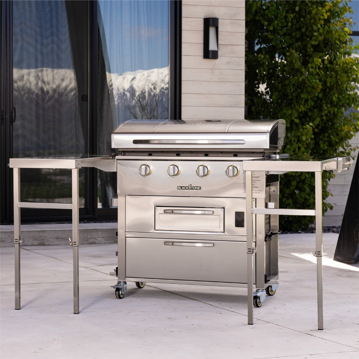 Blackstone Select 36-inch griddle with air fryer, on a patio with side tables up