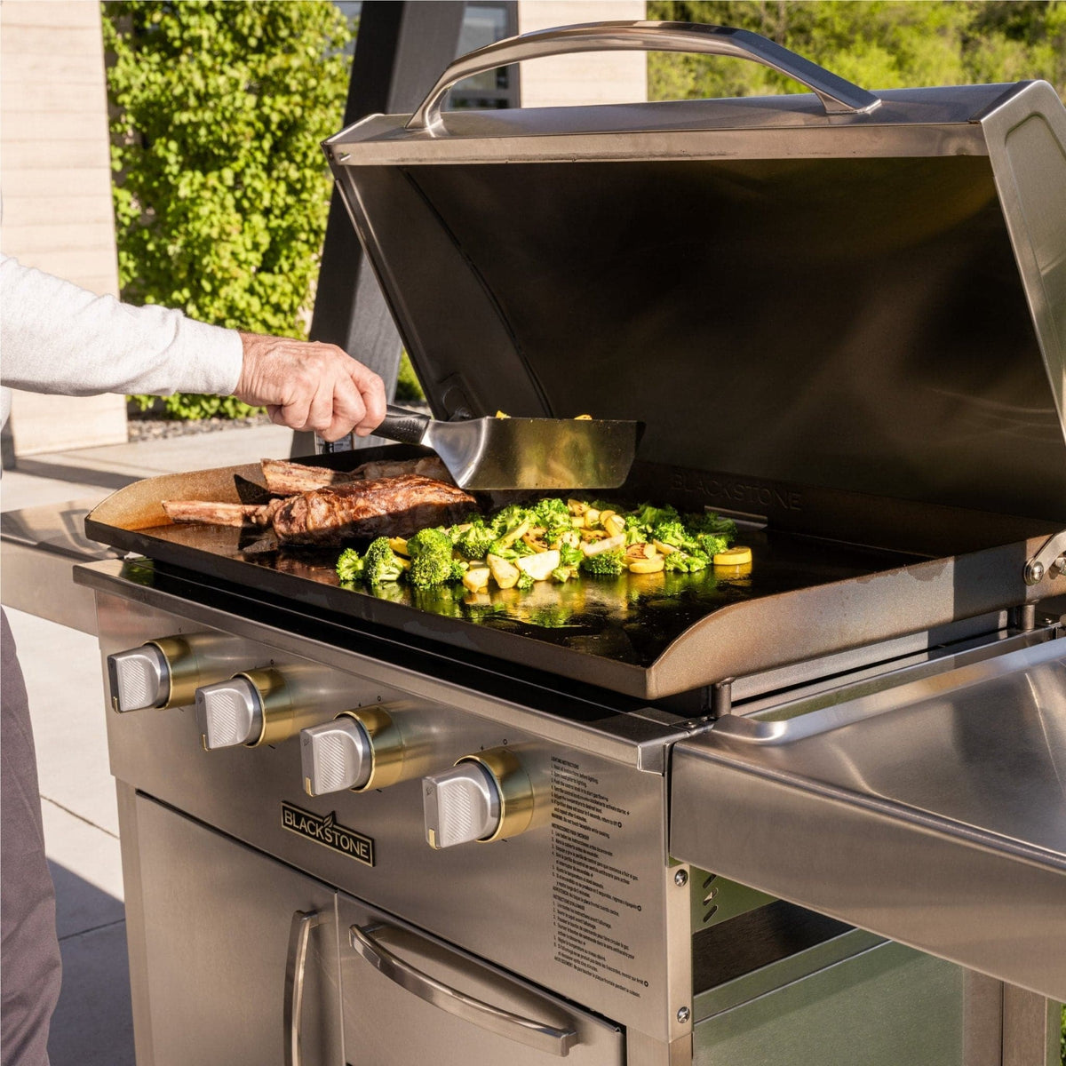 Blackstone Select 36-inch griddle with cabinet, cooking steak and vegetables