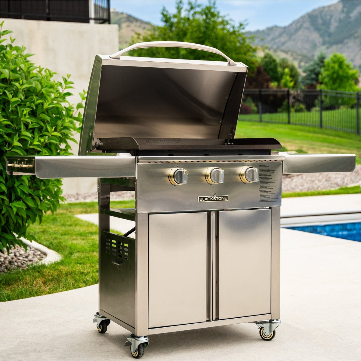Blackstone Select 28-inch griddle with cabinet, on a patio by the pool