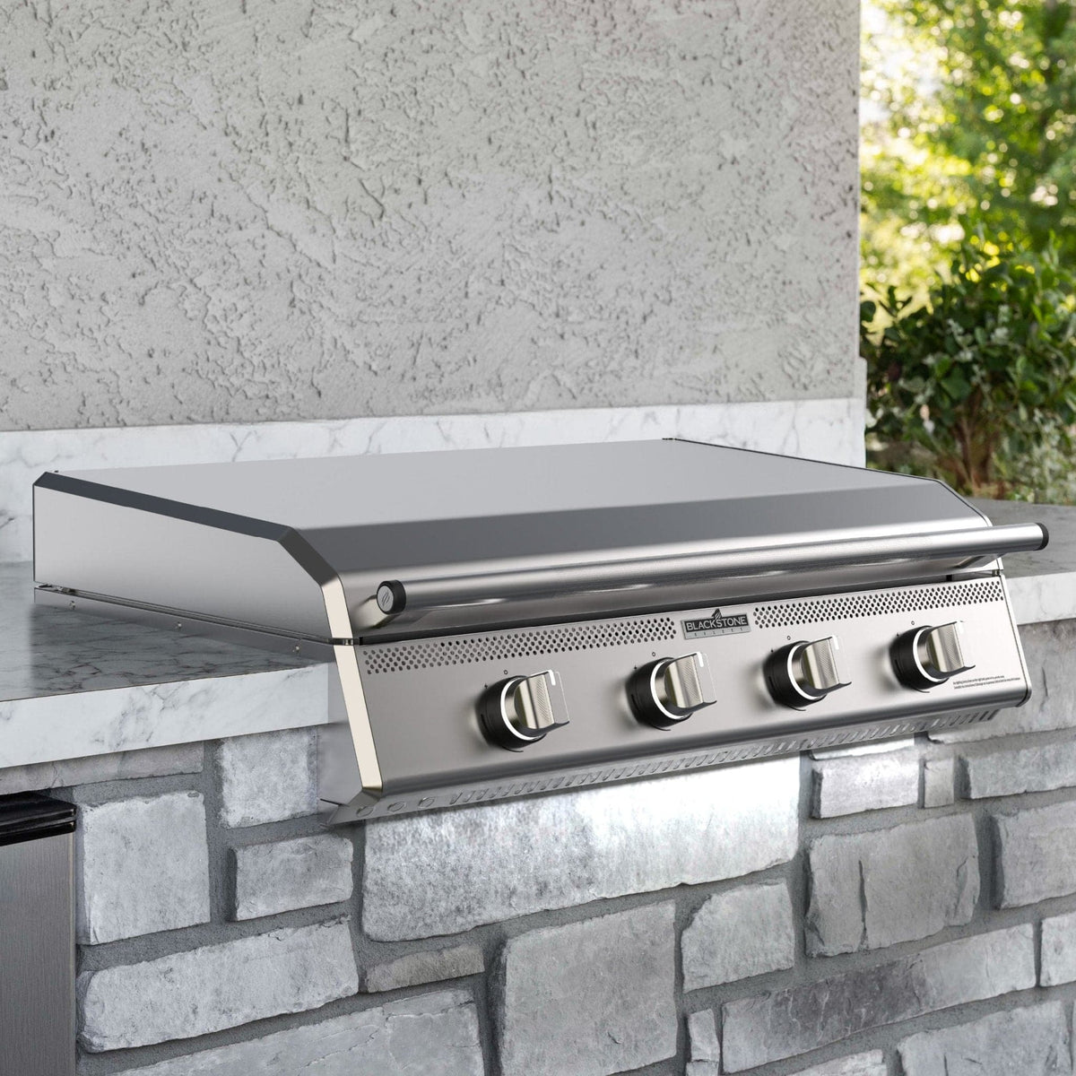 Blackstone Select 36-inch stainless built-in griddle, installed in a stone outdoor kitchen island