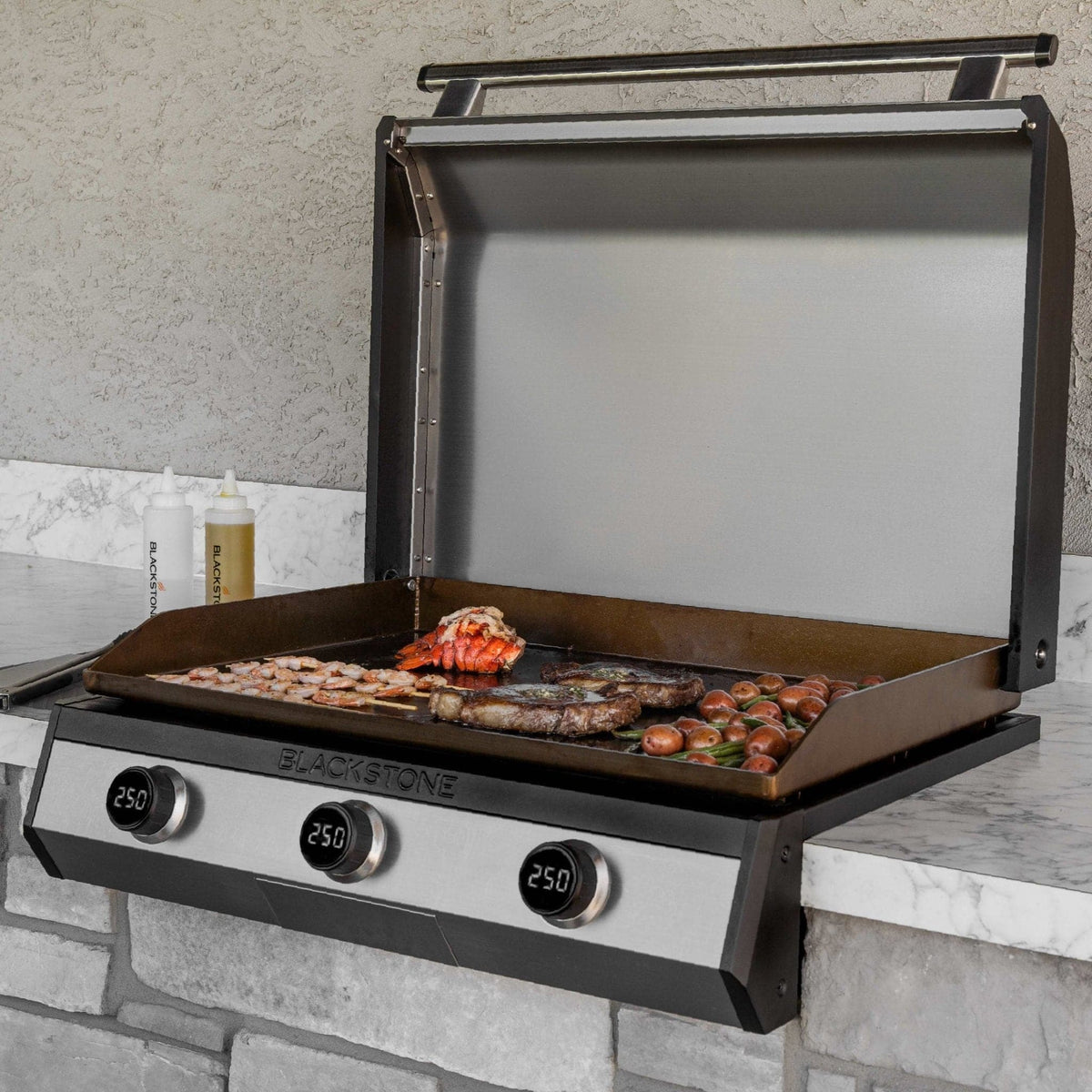 Blackstone 30-inch electric built-in griddle, installed in an island, cooking steak