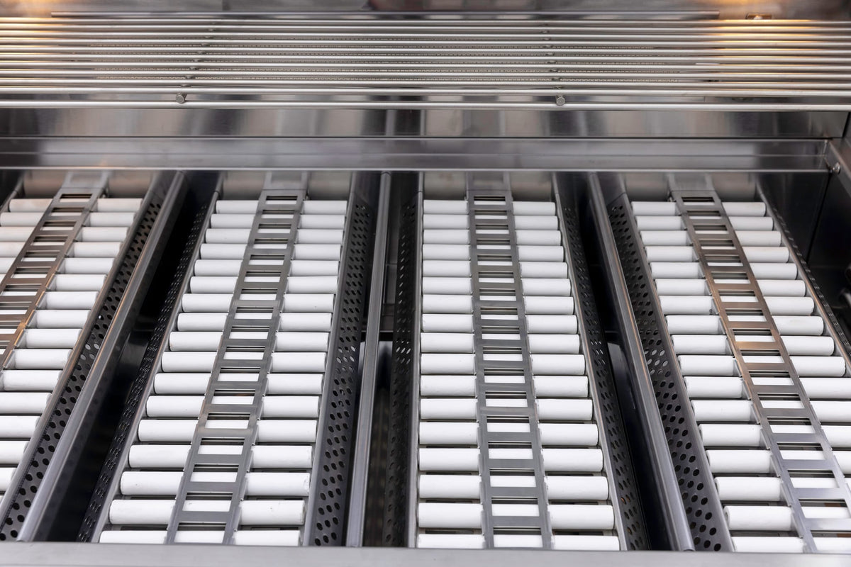 Blaze ceramic flame tamer set of 5, installed in a Blaze grill under the cooking grates
