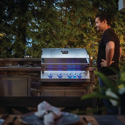 Napoleon BIG32RBSS-1 Grill - Man Standing By Built-In Grill - Lifestyle