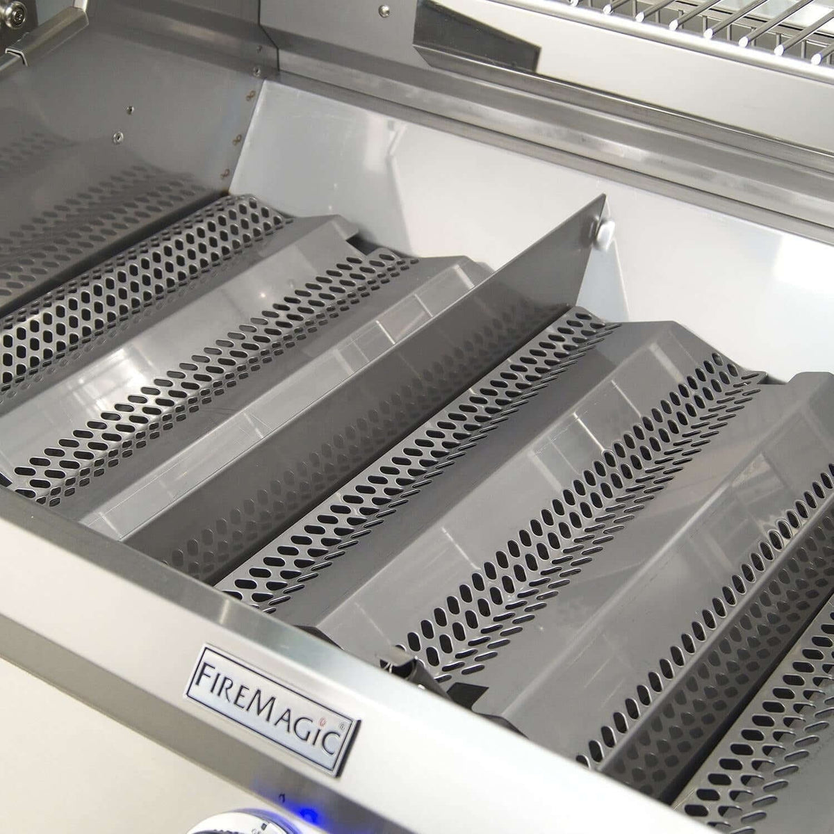 Stainless steel flavor grids installed over the burners of the Echelon E1060i
