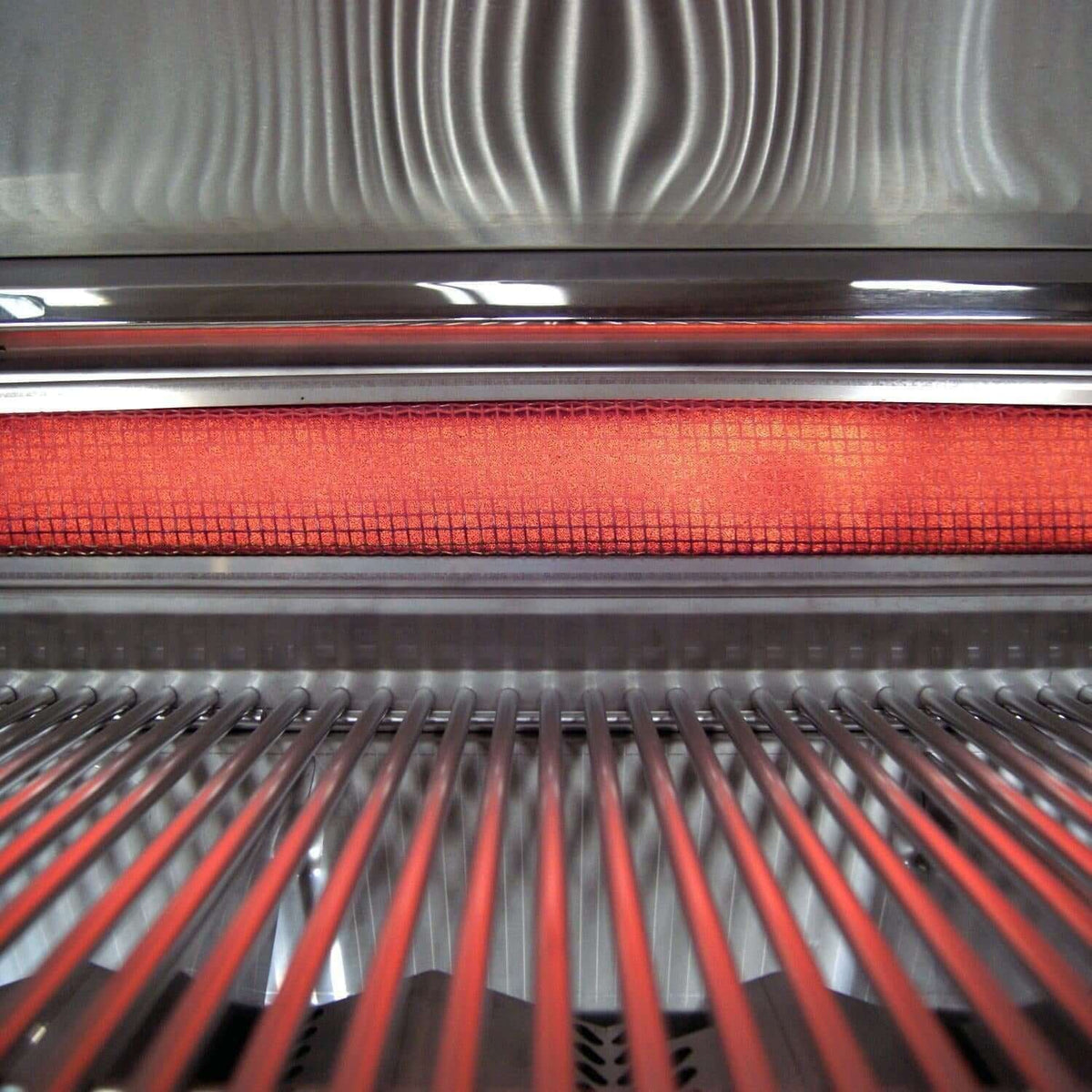 Infrared burner glowing beneath the cooking grates of the Fire Magic Echelon E1060i