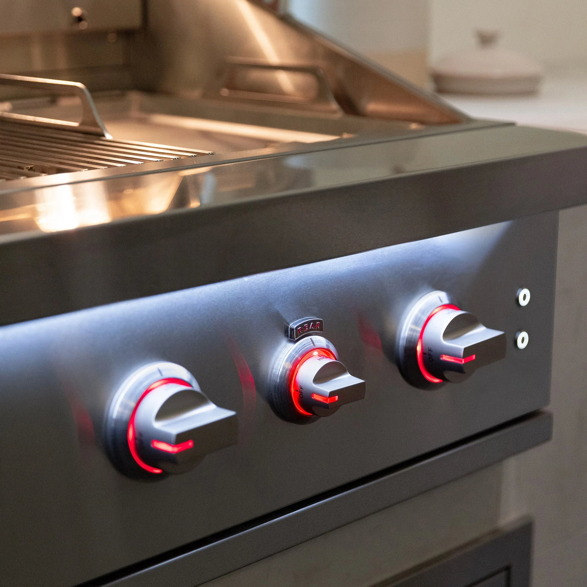 Summerset Quest 30-inch built-in gas grill QST30, front panel lights on, built into an island